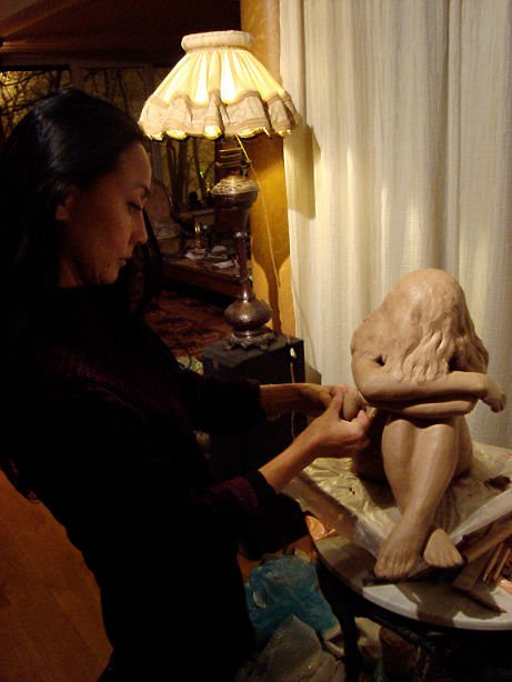 Jeane modelling a clay sculpture